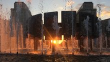 Das Bild zeigt den Brunnen am Strausberger Platz in einer Nahaufnahme mit Blick in Richtung Alexanderplatz bei Sonnenuntergang.
